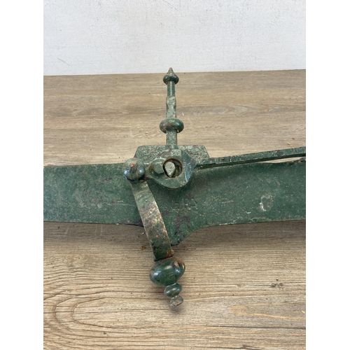 416 - A pair of 19th century cast iron and green painted industrial hoisted weighing scales