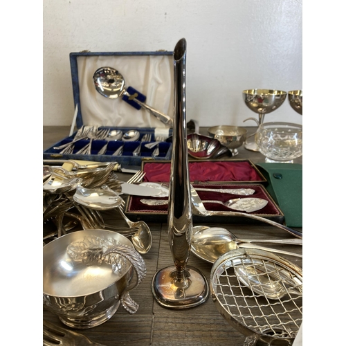 419 - A collection of antique and later metalware to include cutlery, candlesticks, sugar shaker etc.