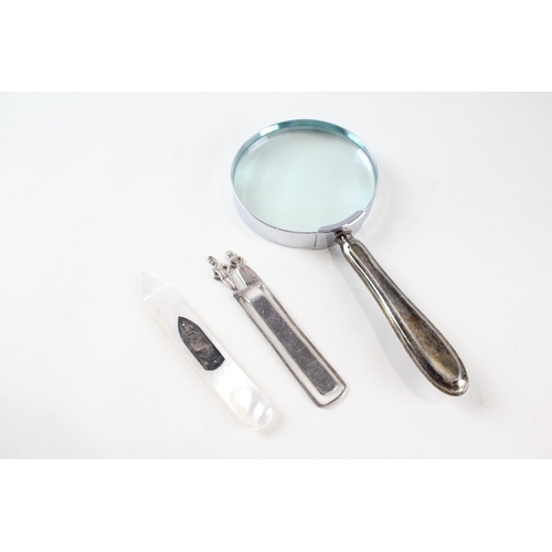 2230 - Three items of .925 silver, one bookmark, one handled magnifying glass and one mother of pearl lette... 