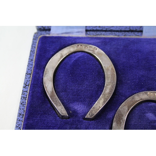 2242 - Two boxed hallmarked Sheffield silver lucky horse shoe ornaments - approx. gross weight 66g