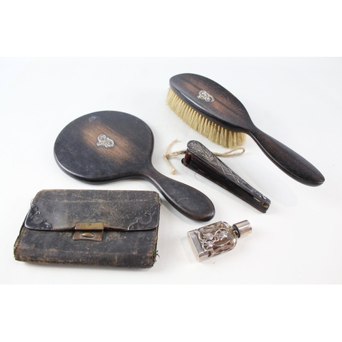 2242A - Five .925 silver overlaid lady's vanity items, one ebony hand mirror, one ebony brush, one leather p... 