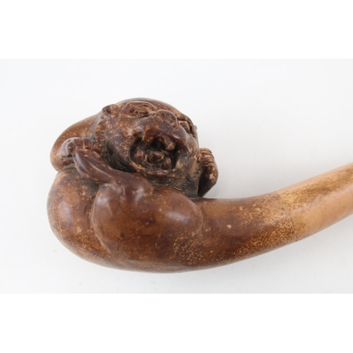 2267 - Three antique smoking pipes to include grotesque clay gargoyle, 18th century petrified wood etc.