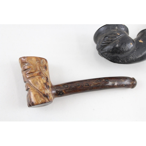 2267 - Three antique smoking pipes to include grotesque clay gargoyle, 18th century petrified wood etc.