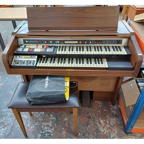 129 - A Hammond 9922K organ with sheet music and stool