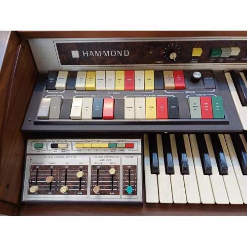 129 - A Hammond 9922K organ with sheet music and stool