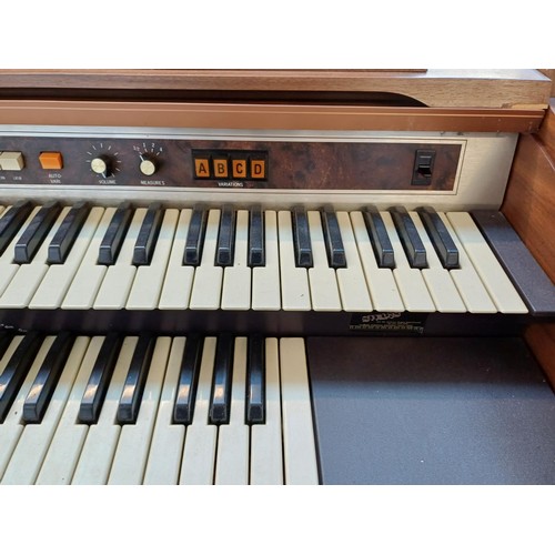 129 - A Hammond 9922K organ with sheet music and stool