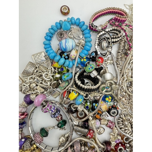 2131 - A collection of fashion charm bracelets and charms