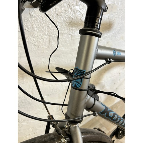 1021 - A Kona Dew men's bike together with a bd Bikes Turbo Trainer