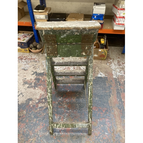 1054 - An early 20th century green painted wooden step ladder