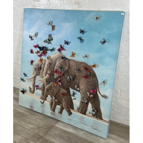 245 - A modern canvas print of elephants with 3D butterflies, signed lower left - approx. 120cm square