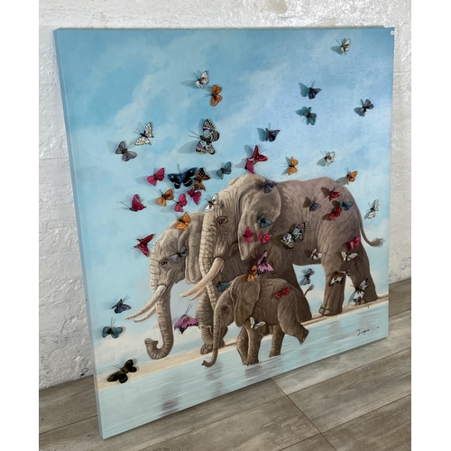 245 - A modern canvas print of elephants with 3D butterflies, signed lower left - approx. 120cm square