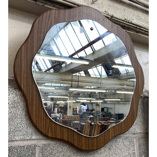 247 - A mid 20th century teak effect floral shaped wall mirror - approx. 60cm diameter