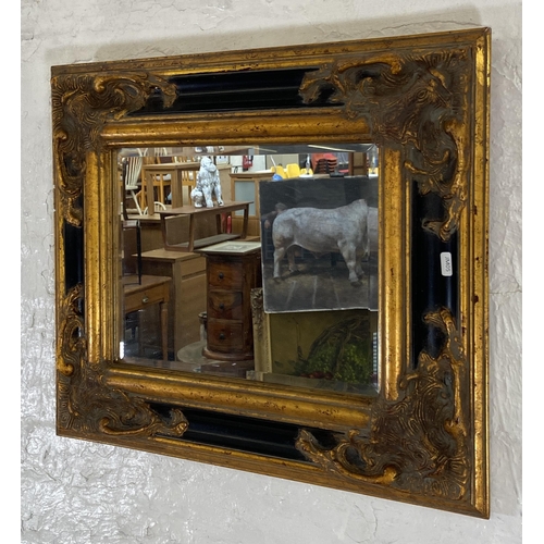 250 - A 19th century style black and gilt framed bevelled edge wall mirror - approx. 51cm high x 60cm wide