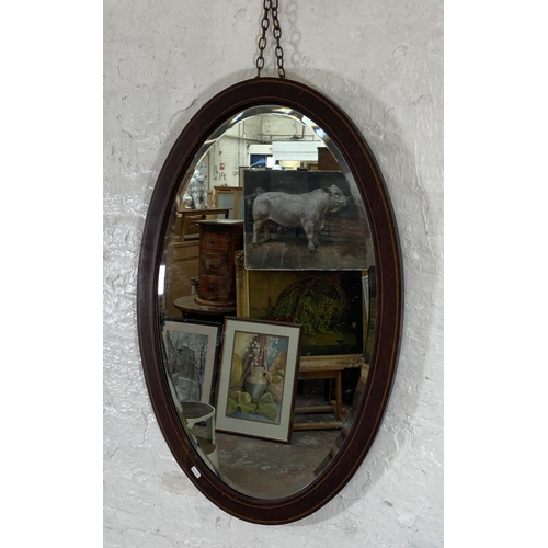 260 - An Edwardian inlaid mahogany framed bevelled edge oval wall mirror - approx. 92cm high x 60cm wide