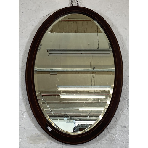 260 - An Edwardian inlaid mahogany framed bevelled edge oval wall mirror - approx. 92cm high x 60cm wide