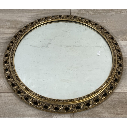 272 - A mid 20th century gilt framed circular wall mirror - approx. 60cm diameter