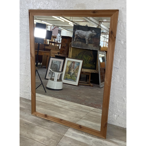 279 - A modern pine framed overmantel wall mirror - approx. 100cm high x 132cm wide