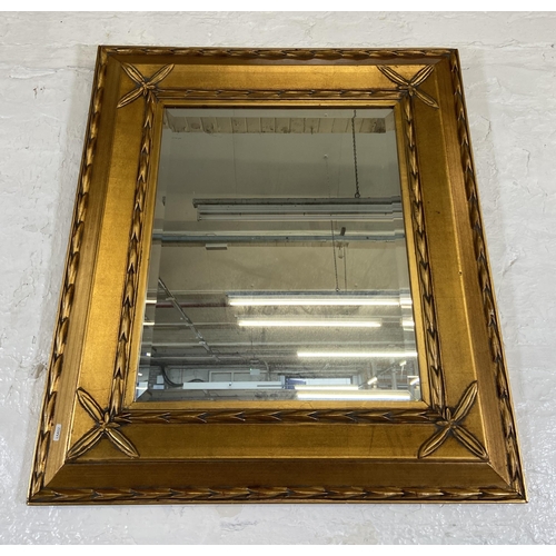 280 - A modern gilt framed bevelled edge wall mirror - approx. 89cm high x 80cm wide