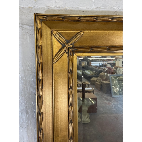 280 - A modern gilt framed bevelled edge wall mirror - approx. 89cm high x 80cm wide