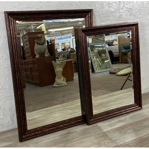 281 - Two modern bevelled edge wall mirrors - largest approx. 105cm high x 74cm wide