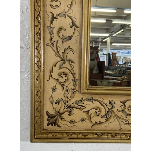 282 - A modern hand painted floral decorated gilt framed wall mirror - approx. 120cm high x 98cm wide