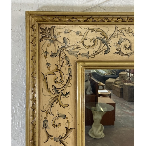 282 - A modern hand painted floral decorated gilt framed wall mirror - approx. 120cm high x 98cm wide