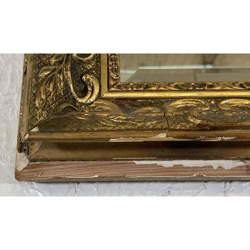 284 - A gilt framed bevelled edge overmantel wall mirror - approx. 74cm high x 100cm wide