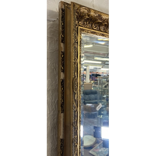 284 - A gilt framed bevelled edge overmantel wall mirror - approx. 74cm high x 100cm wide