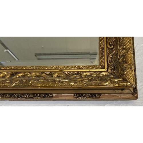 284 - A gilt framed bevelled edge overmantel wall mirror - approx. 74cm high x 100cm wide