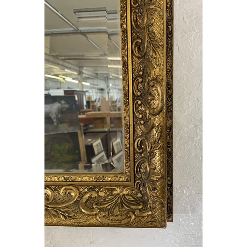 284 - A gilt framed bevelled edge overmantel wall mirror - approx. 74cm high x 100cm wide