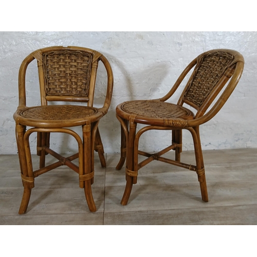 100 - A mid 20th century wicker and cane three piece dining suite comprising table and two chairs - table ... 