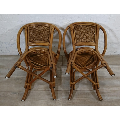 100 - A mid 20th century wicker and cane three piece dining suite comprising table and two chairs - table ... 