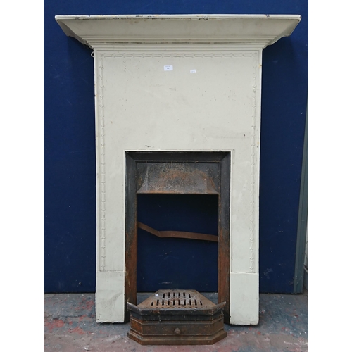 102 - A Victorian style cast iron fire surround - approx. 132cm high x 99cm wide x 18cm deep