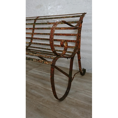 104A - A 19th century wrought iron strap work garden bench - approx. 82cm high x 150cm wide x 70cm deep