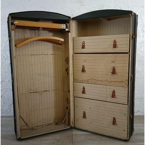 108 - An early 20th century blue painted fibreboard and wooden banded travel trunk with fitted interior