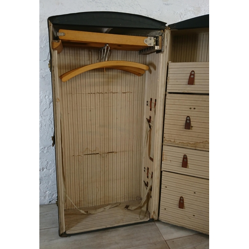 108 - An early 20th century blue painted fibreboard and wooden banded travel trunk with fitted interior