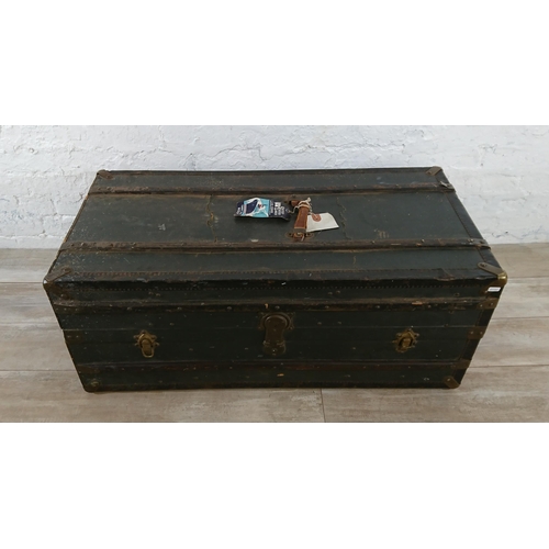 108 - An early 20th century blue painted fibreboard and wooden banded travel trunk with fitted interior