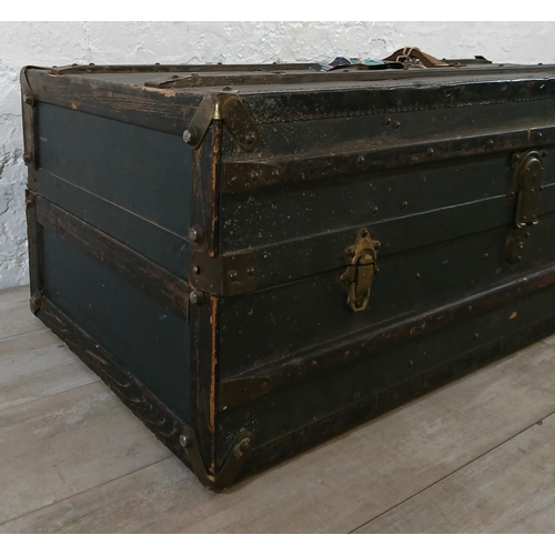 108 - An early 20th century blue painted fibreboard and wooden banded travel trunk with fitted interior