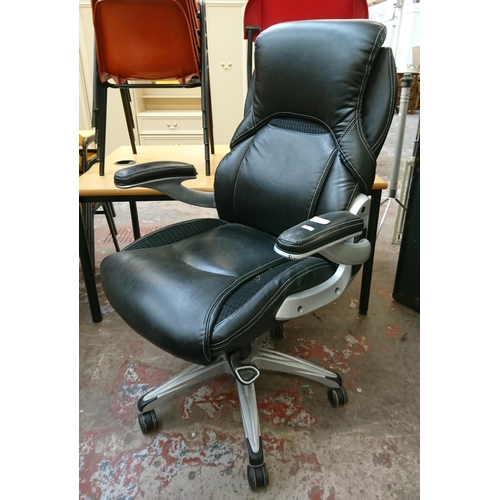 109 - A modern True Wellness black vinyl adjustable swivel desk chair - approx. 103cm high x 75cm wide