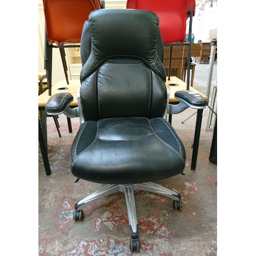 109 - A modern True Wellness black vinyl adjustable swivel desk chair - approx. 103cm high x 75cm wide