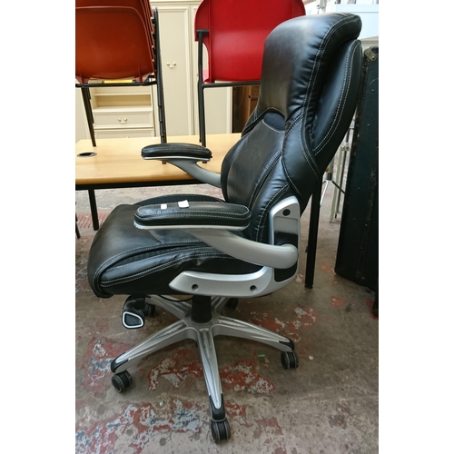 109 - A modern True Wellness black vinyl adjustable swivel desk chair - approx. 103cm high x 75cm wide