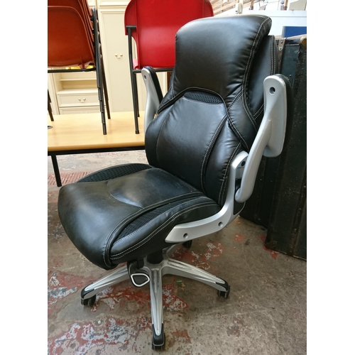 109 - A modern True Wellness black vinyl adjustable swivel desk chair - approx. 103cm high x 75cm wide