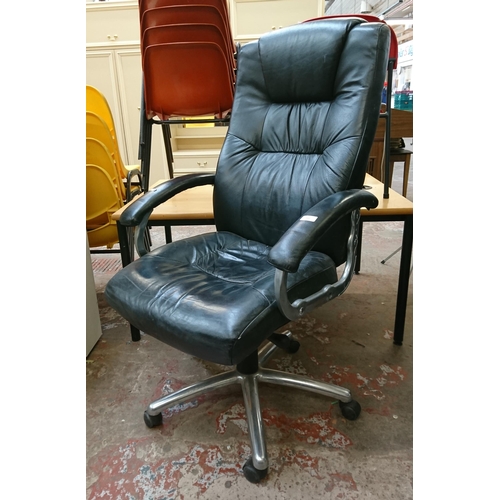 110 - A black leather adjustable swivel desk chair - approx. 117cm high x 67cm wide