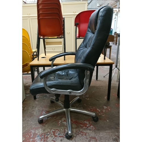 110 - A black leather adjustable swivel desk chair - approx. 117cm high x 67cm wide