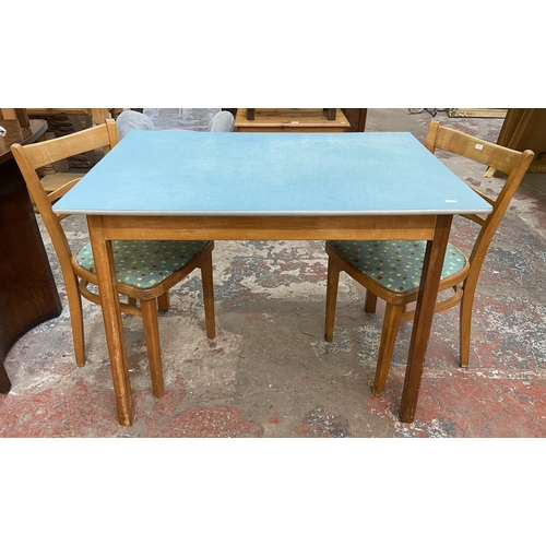 117 - A 1950s blue laminate and beech rectangular kitchen table and two chairs - table approx. 76cm high x... 