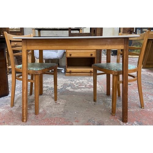 117 - A 1950s blue laminate and beech rectangular kitchen table and two chairs - table approx. 76cm high x... 