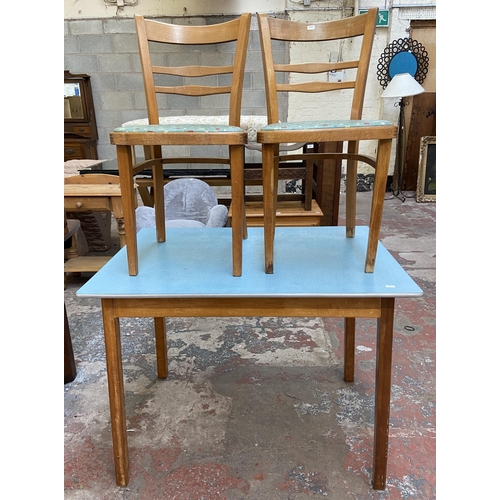 117 - A 1950s blue laminate and beech rectangular kitchen table and two chairs - table approx. 76cm high x... 