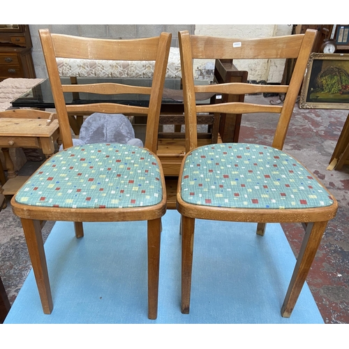 117 - A 1950s blue laminate and beech rectangular kitchen table and two chairs - table approx. 76cm high x... 