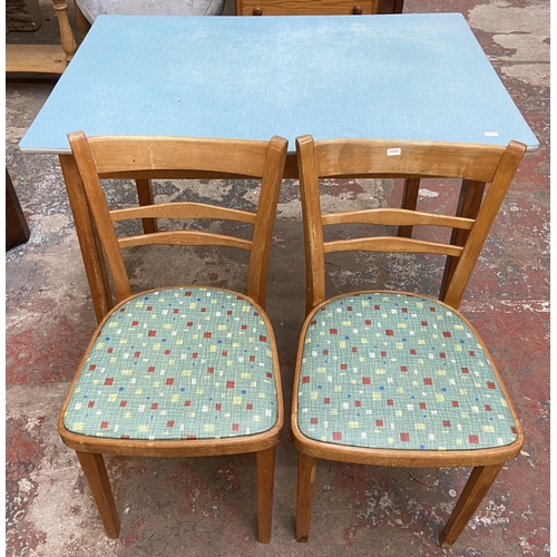 117 - A 1950s blue laminate and beech rectangular kitchen table and two chairs - table approx. 76cm high x... 