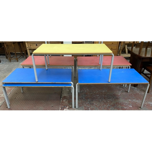 121 - Four mid 20th century laminate and tubular metal school desks